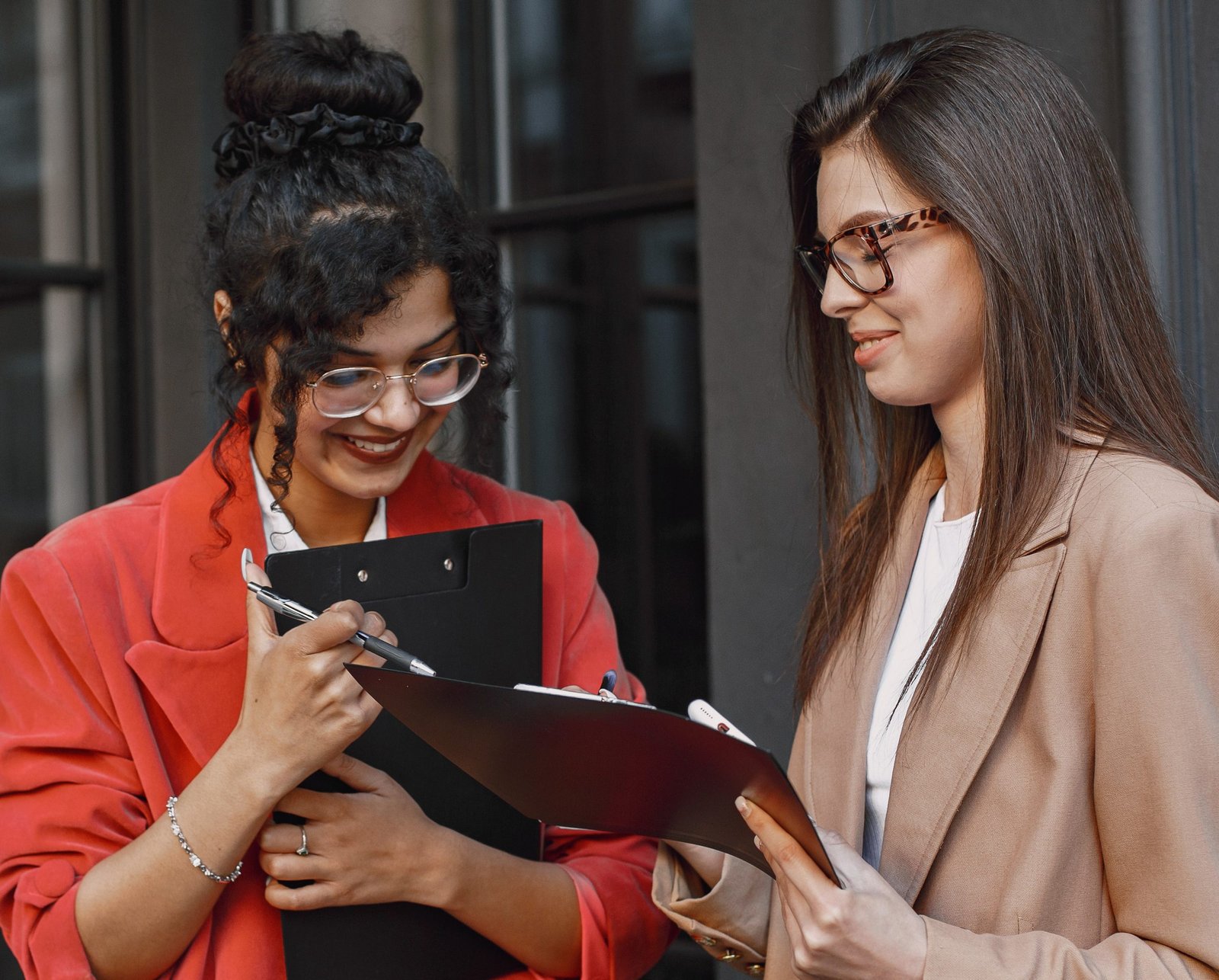 female-colleagues-discussing-data-cafe-outdoor