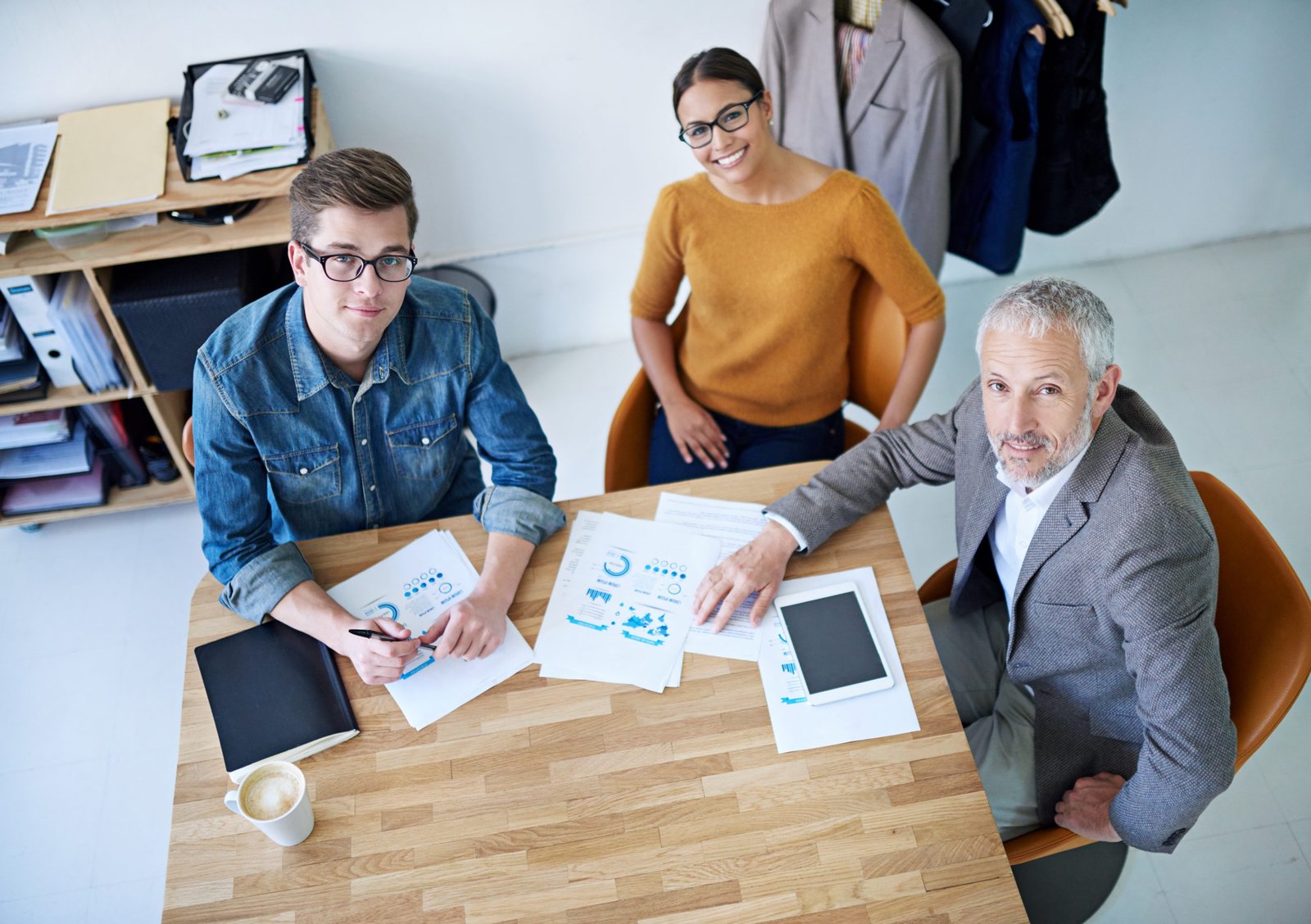 Portrait of creative businesspeople having a meeting around a table.